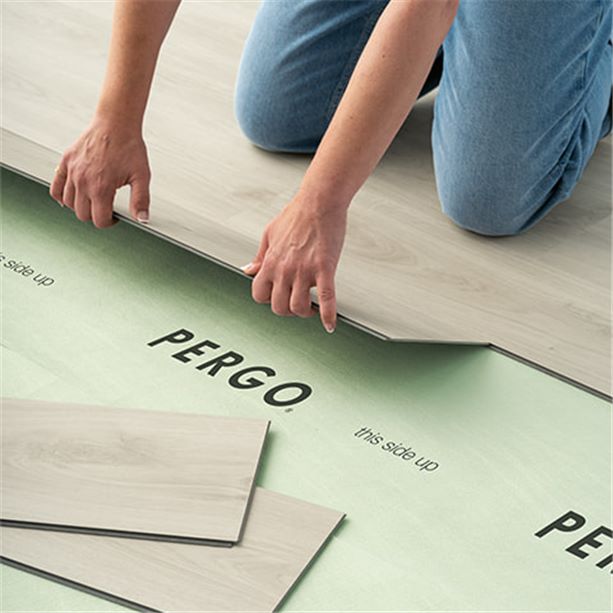 woman installing a pergo vinyl floor on an underlay